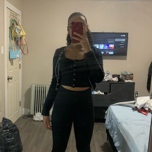Black strapped crop top and black pull over shirt